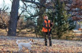 Boy and a dog squirrel hunting